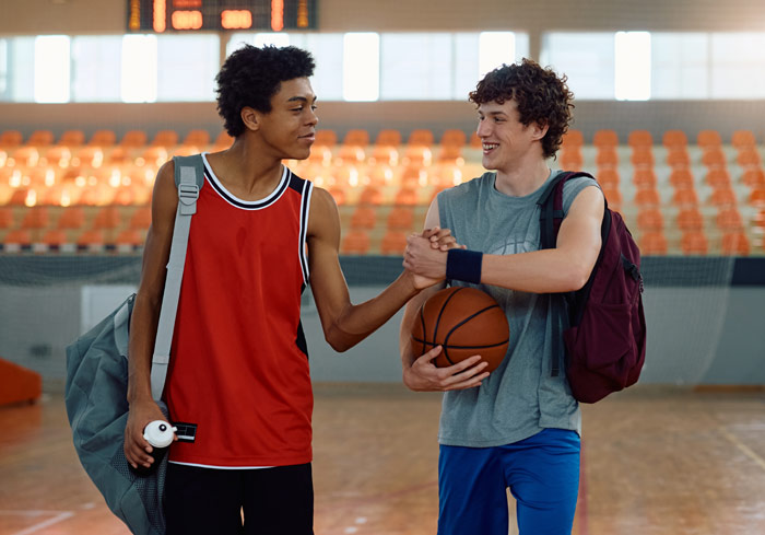 Jeunes joueurs de basket saluant après l'entraînement sportif.